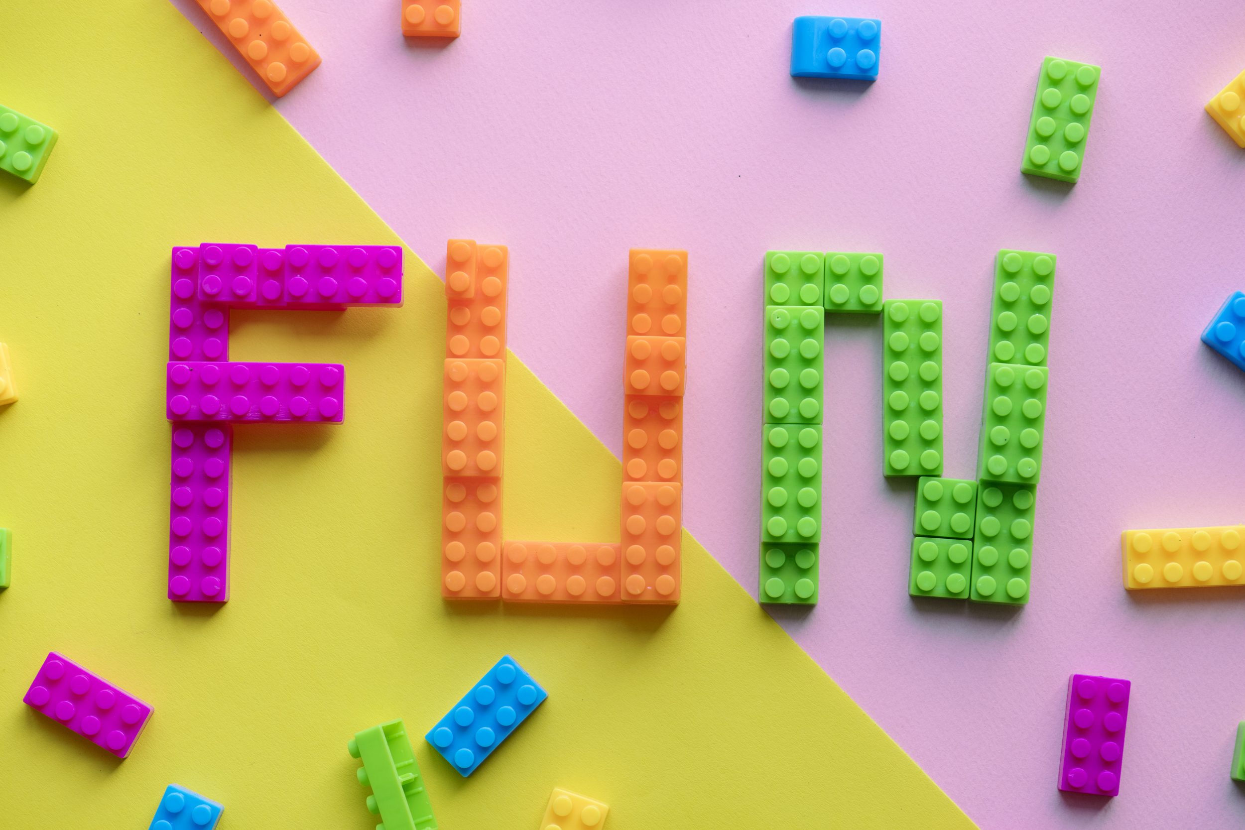 Fun spelled word with plastic blocks background